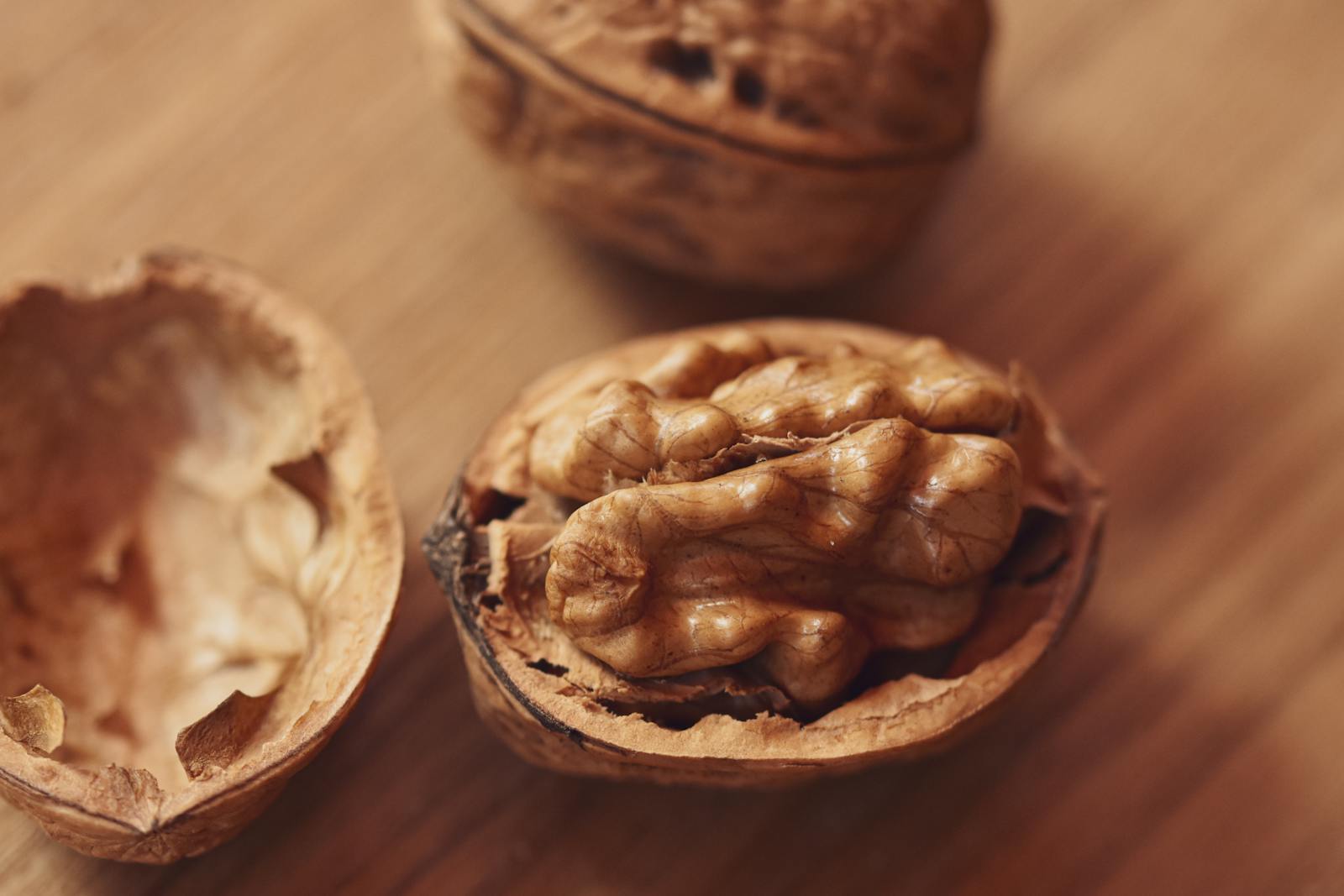 A detailed close-up of a walnut partially shelled, showcasing texture and natural form.