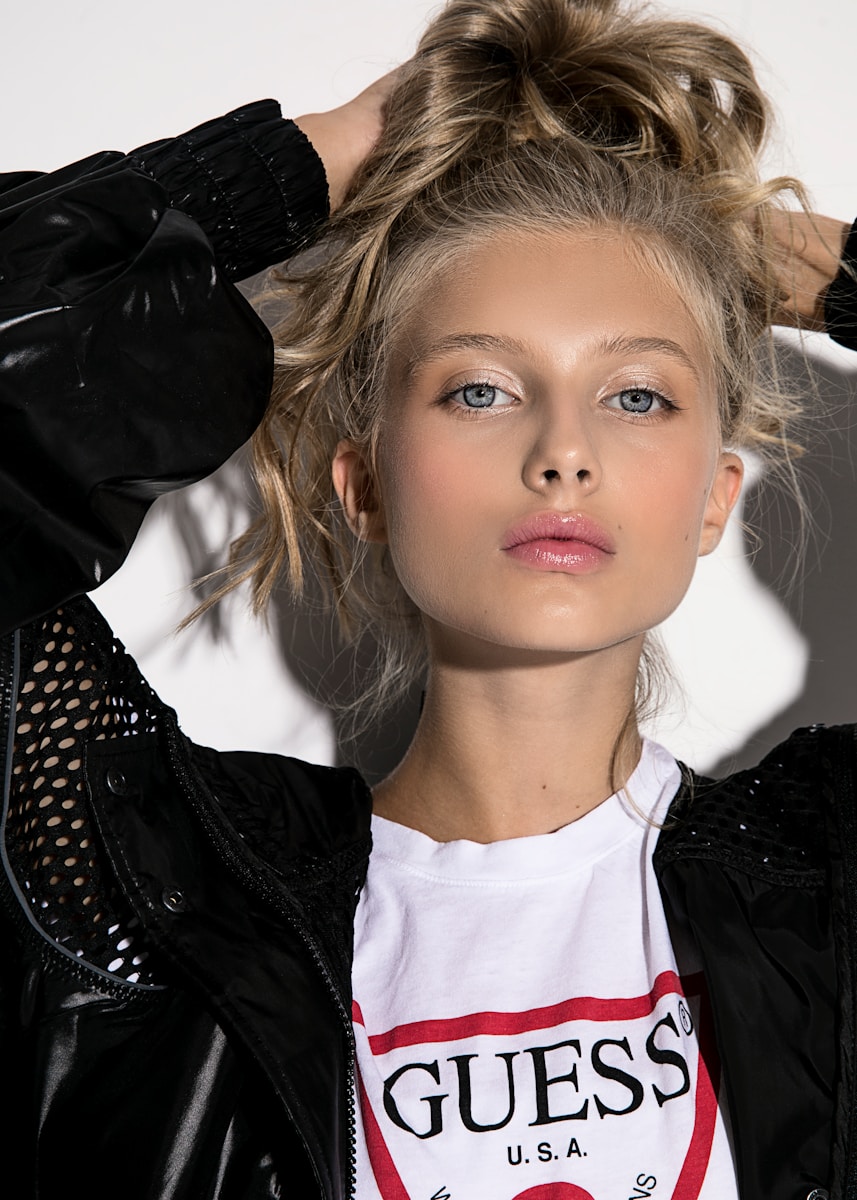 Young girl with blonde hair in a white t-shirt